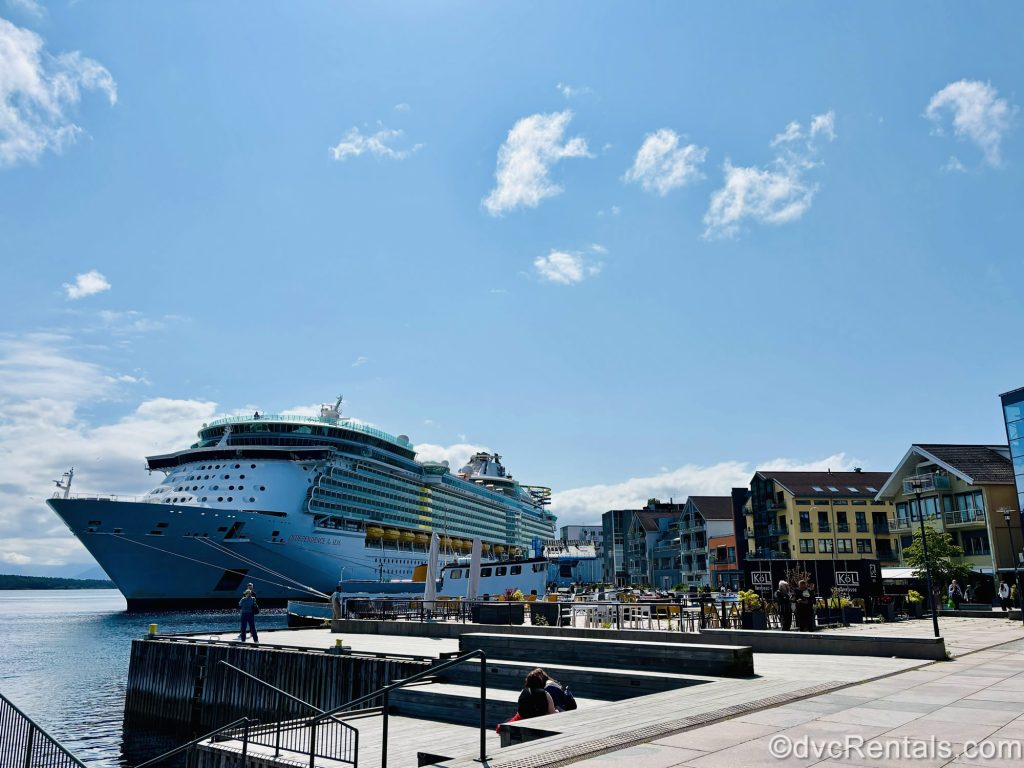 Royal Caribbean’s Independence of the Seas cruise ship is seen docked under the sun by the waterfront of Molde, Norway.