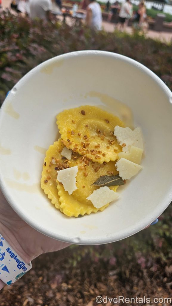 Pumpkin Marscapone Ravioli from the Forest & Field booth at the EPCOT Food & Wine Festival is served in a white bowl.