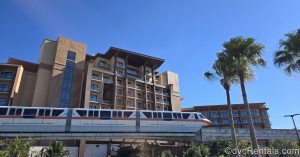 The monorail passes by the Island Tower at Disney’s Polynesian Villas & Bungalows under a sunny sky.