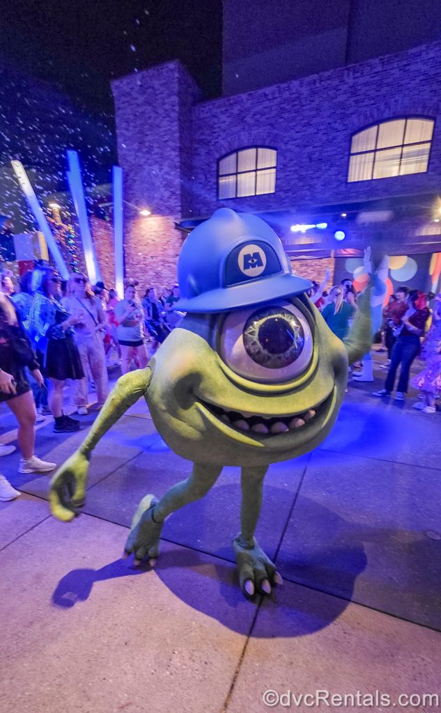 Mike Wazowski from Monsters Inc. dances with event guests at the Pixar Disco during Disney Jollywood Nights.