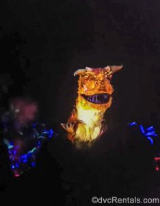 An animatronic Carnotaurus dinosaur roars at guests in the dark during the DINOSAUR attraction at Disney’s Animal Kingdom Theme Park.