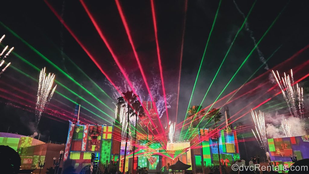 Red and green lasers fill the sky over the Chinese Theatre at Disney’s Hollywood Studios along with glittering fireworks during a showing of Jingle Bell, Jingle BAM!