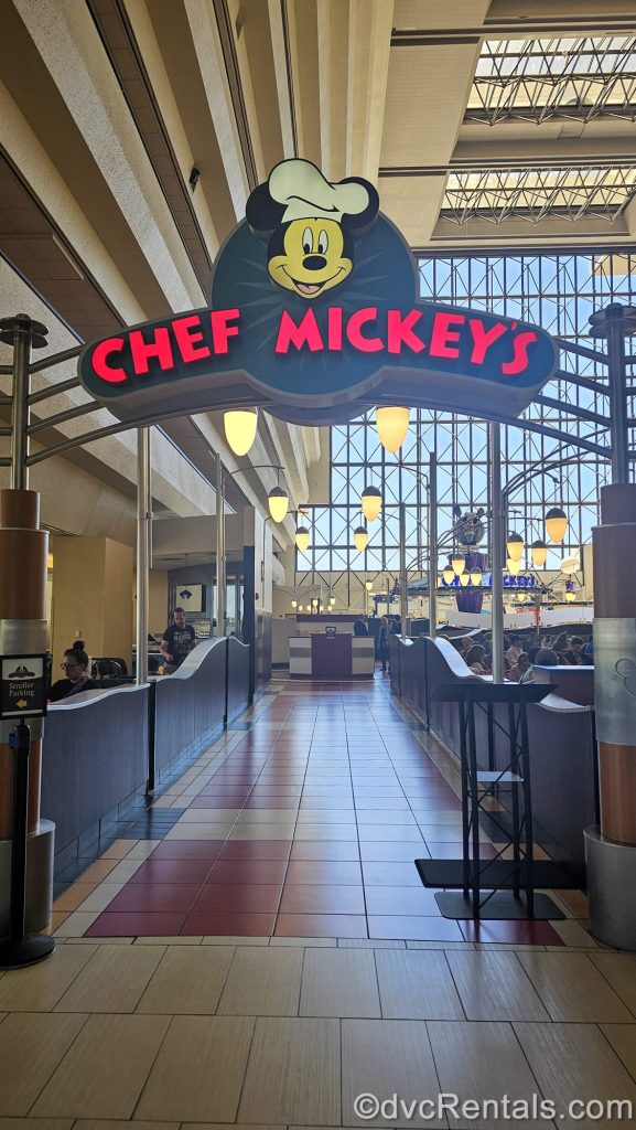 A drawing of Mickey Mouse in a chef’s hat tops the red sign for Chef Mickey’s restaurant at Disney’s Contemporary Resort.