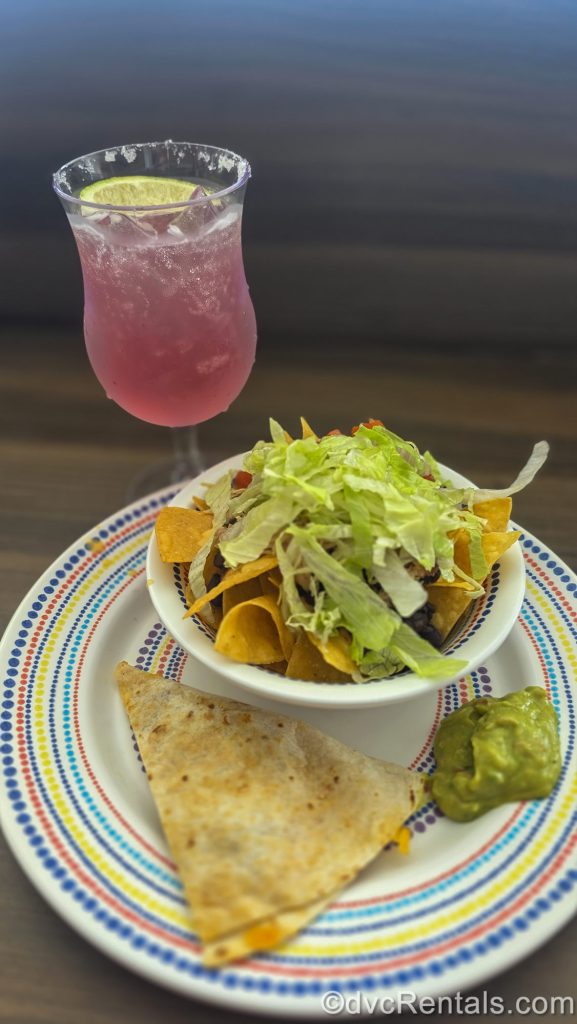 A quesadilla, nacho bowl, guacamole, and a pink fizzy drink from El Loco Fresh onboard Royal Caribbean’s Wonder of the Seas.