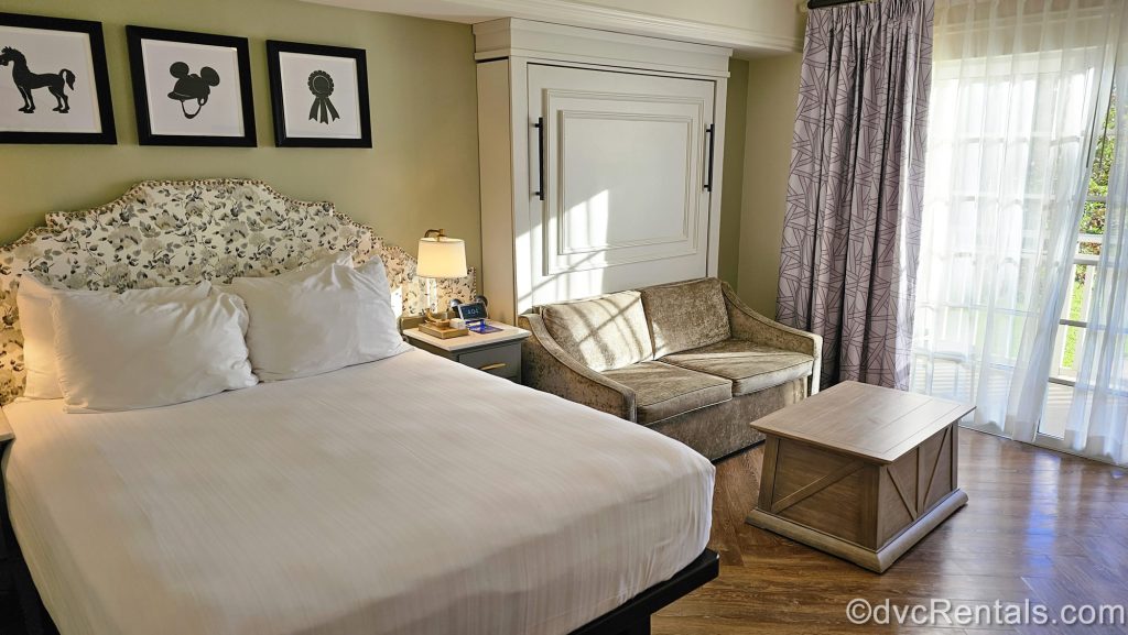 The interior of a Deluxe Studio Standard at Disney’s Saratoga Springs Resort & Spa is seen. The room is decorated with light neutral colors and Disney horse-inspired art and accessories.