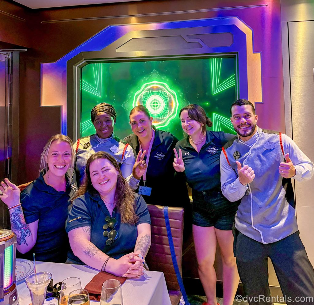 David’s Vacation Club Rentals team members pose with smiles with two dining team Cast Members in the Worlds of Marvel restaurant aboard the Disney Destiny.