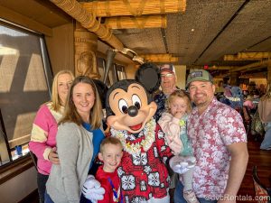 Guest blogger Christie Hecht and her family pose with Mickey Mouse in his Hawaiian outfit at ‘Ohana and Disney’s Polynesian Villas & Bungalows