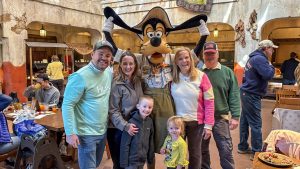 Guest blogger Christie Hecht poses with her family and Goofy at Tusker House at Disney’s Animal Kingdom Theme Park.