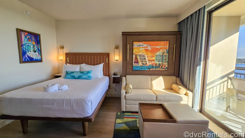 A Deluxe Studio at Bay Lake Tower at Disney’s Contemporary Resort. The room is decorated with neutrals, pops of multiple bright colors, and Disney parks-inspired artwork.
