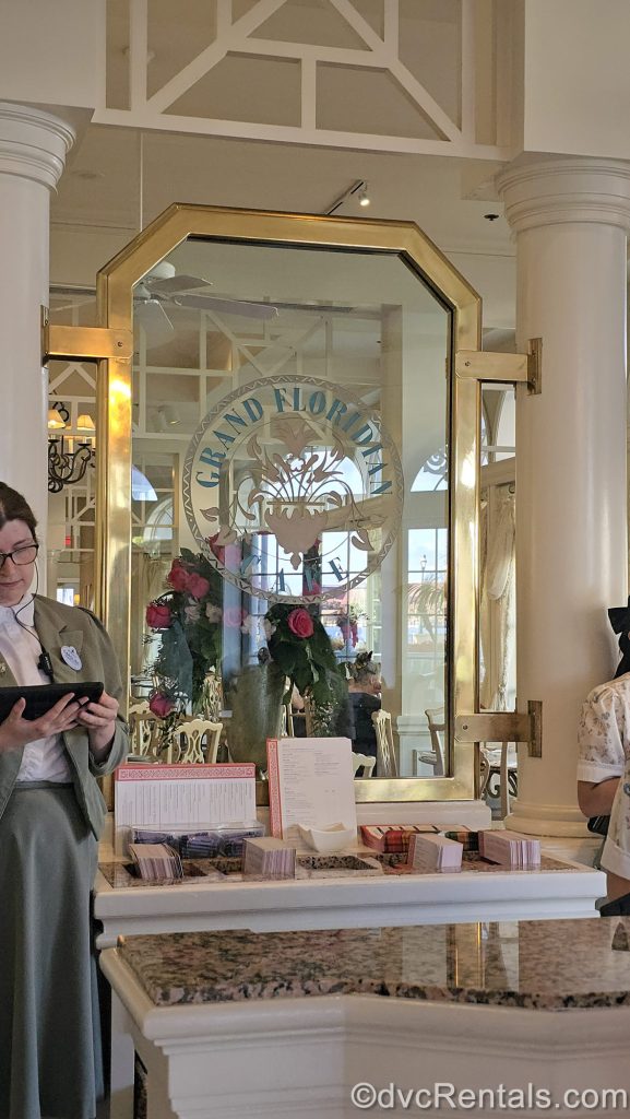 Cast Members prepare to seat guests at the podium entrance to Grand Floridian Café at Disney’s Grand Floridian Resort & Spa.