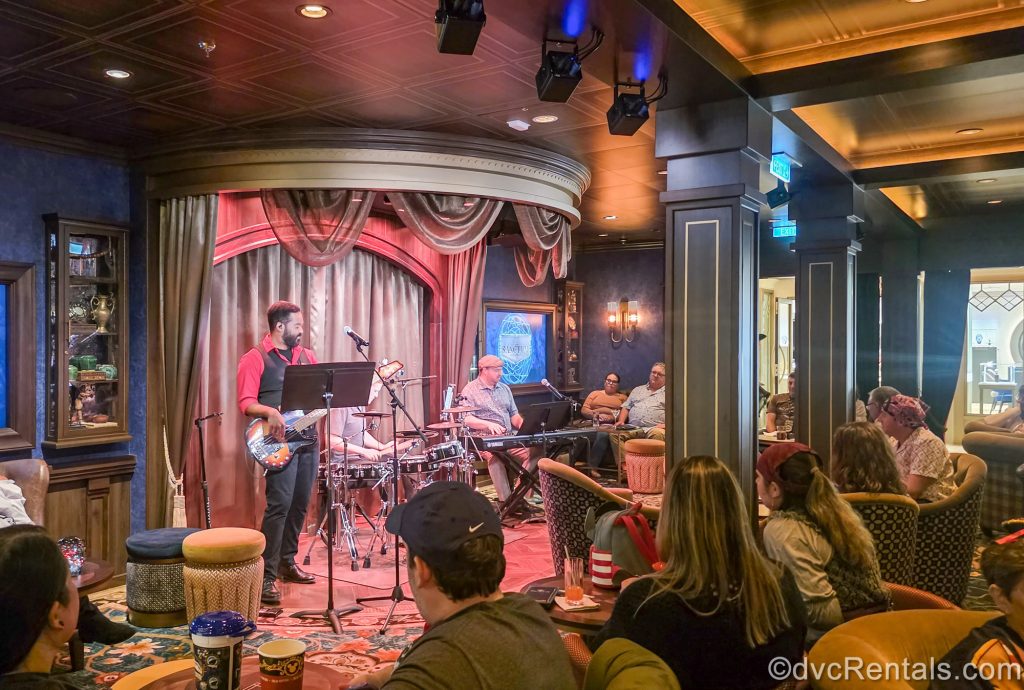 A live band performs in the Sanctum lounge onboard the Disney Destiny as guests enjoy the music