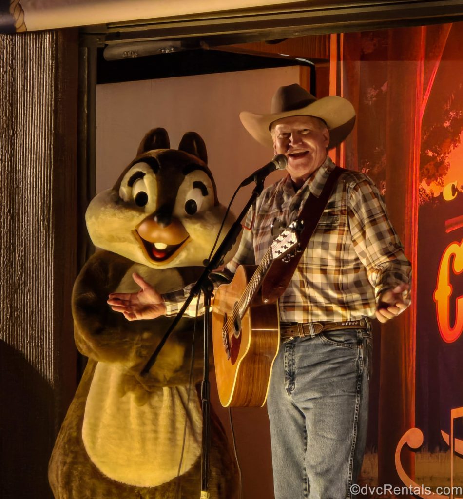 The cowboy campfire singer and Chip perform during Chip ‘n’ Dale’s Campfire Sing-A-Long at Disney’s Fort Wilderness Resort.