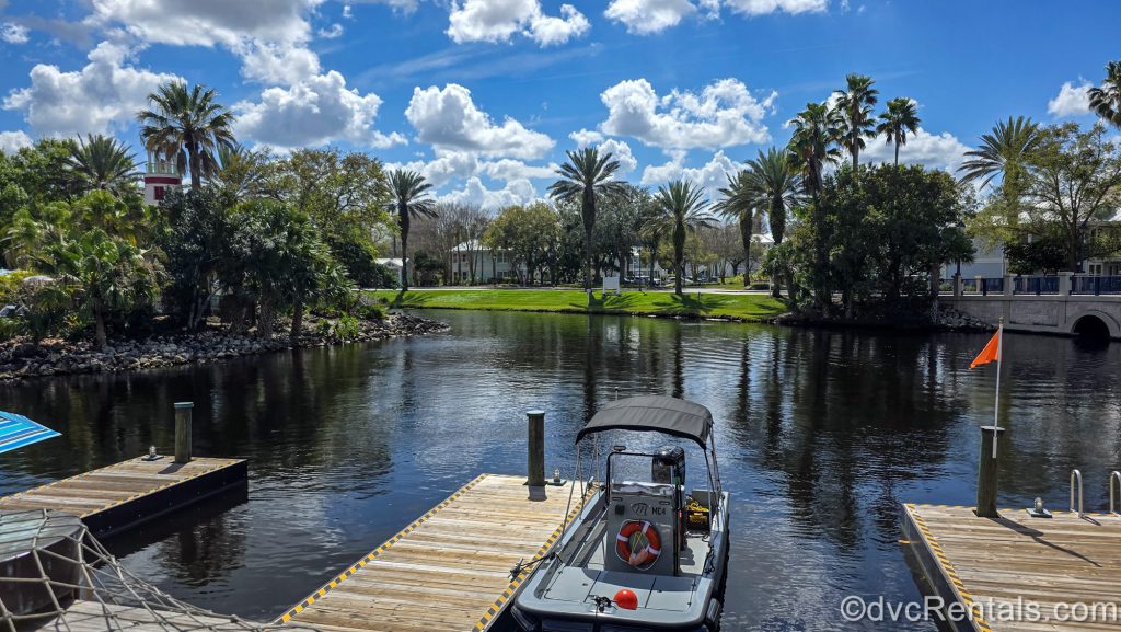 A boat sits docked in the sunshine outside of the Hospitality House at Disney’s Old Key West Resort.