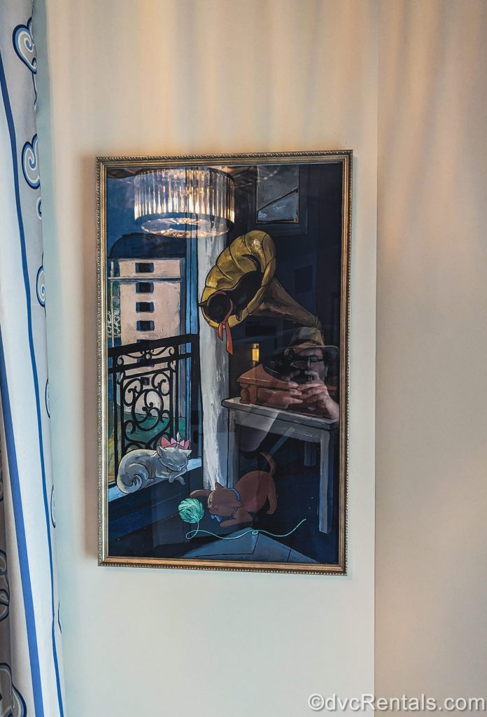 A framed piece of art depicting the kittens from Disney’s Aristocats at Disney’s Riviera Resort is seen.