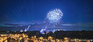 Blue and white fireworks sparkle over the Magic Kingdom in the night sky as seen from Bay Lake Tower at Disney’s Contemporary Resort.