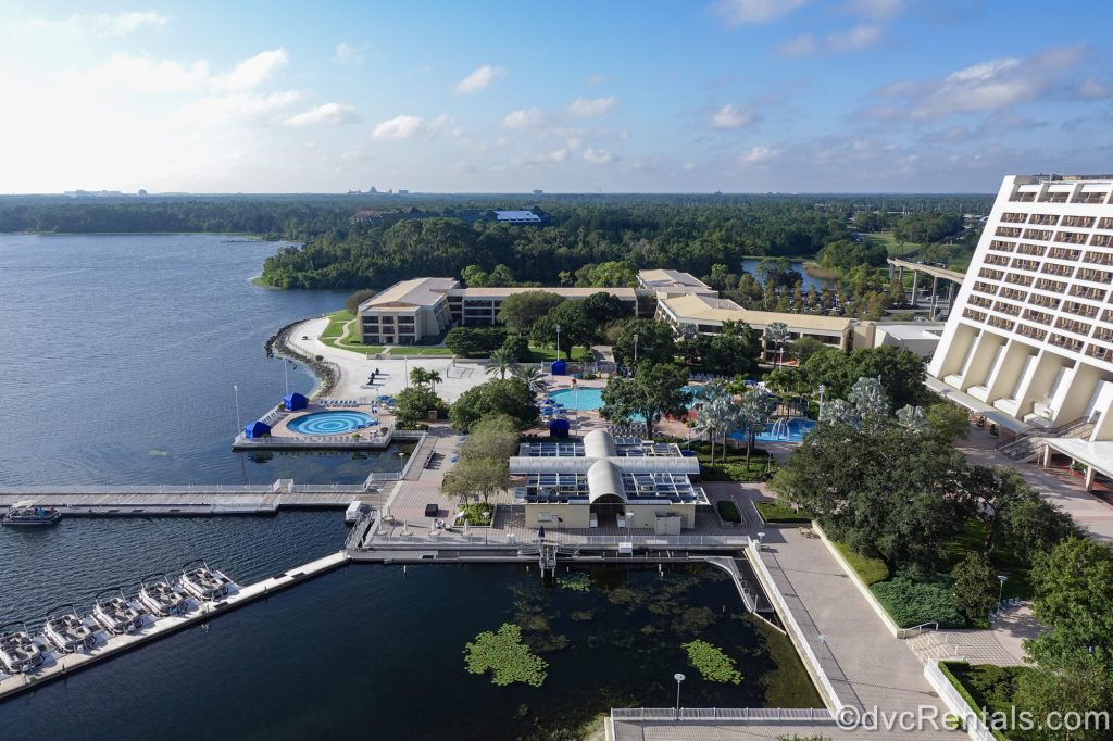 Bay Lake and the grounds of Disney’s Contemporary Resort are seen under a blue sky from a balcony at Bay Lake Tower.
