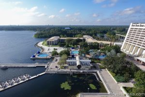Bay Lake and the grounds of Disney’s Contemporary Resort are seen under a blue sky from a balcony at Bay Lake Tower.