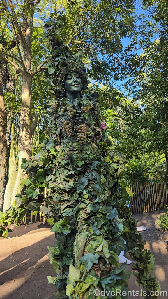 DiVine, a character made of green foliage performs for guests at Disney’s Animal Kingdom Theme Park.