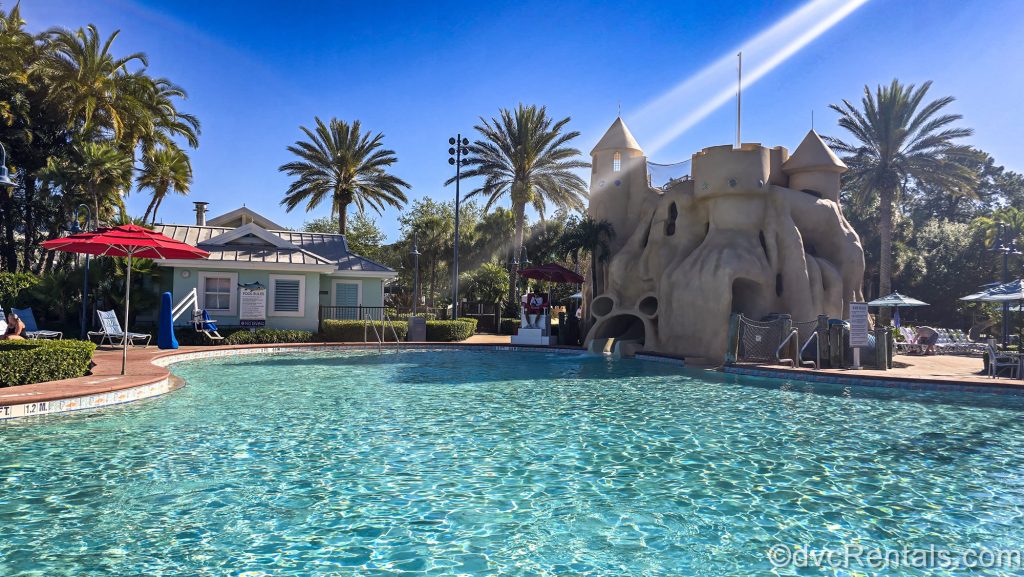 The Sandcastle Pool at Disney’s Old Key West Resort is seen under a bright, sunny sky.