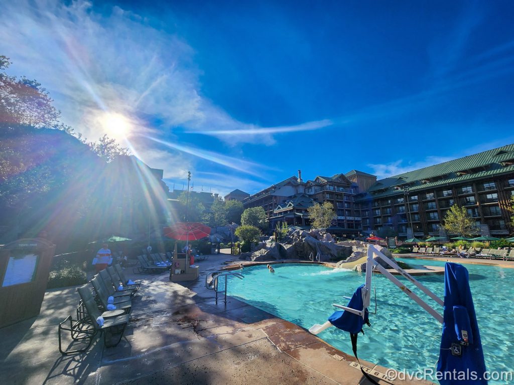 The sun shines brightly in the sky as guests enjoy the Copper Creek Springs Pool at Disney’s Wilderness Lodge.