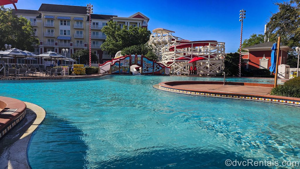 The Luna Park Pool at Disney’s BoardWalk Villas is seen under a bright, blue sky.