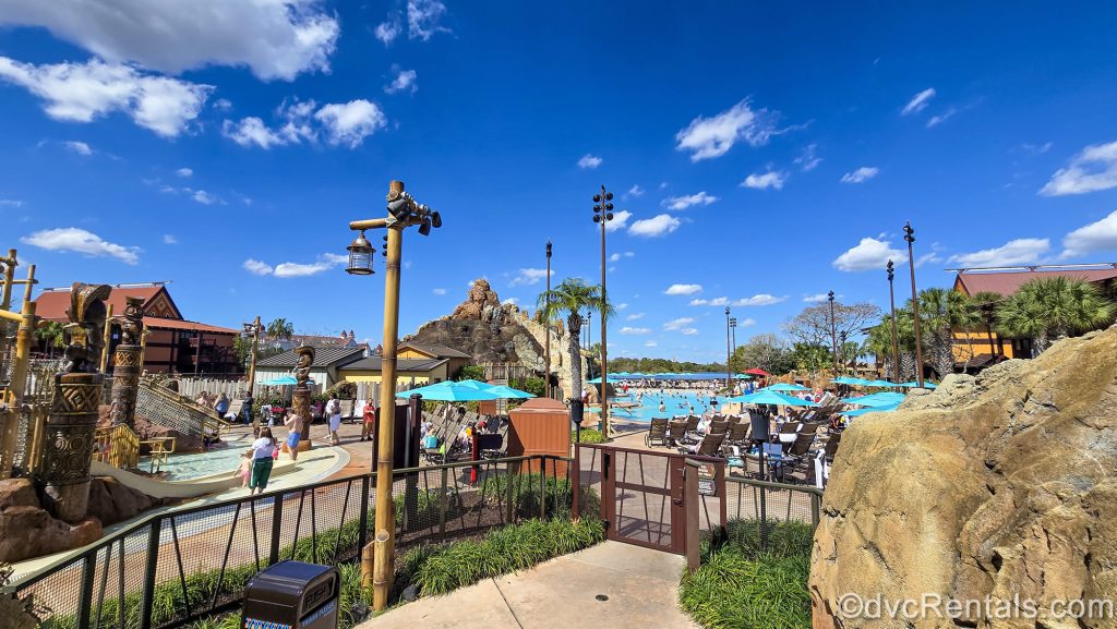 The sun shines over the Lava Pool as guests enjoy the water and island-inspired splash pad area.