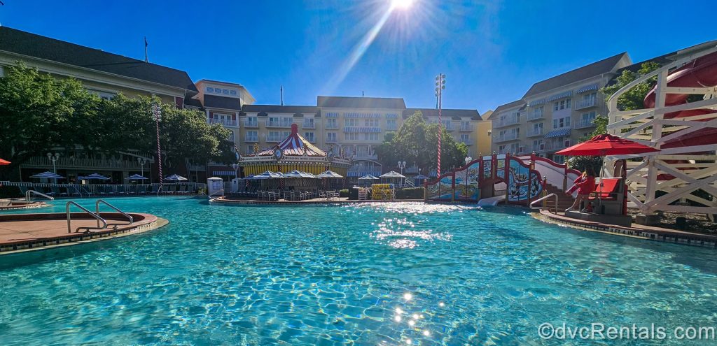 The Luna Park Pool and Leaping Horse Libations at Disney’s BoardWalk Villas are seen under a sunny blue sky.