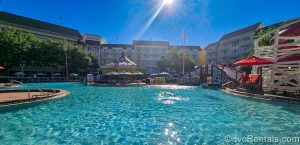 The Luna Park Pool and Leaping Horse Libations at Disney’s BoardWalk Villas are seen under a sunny blue sky.