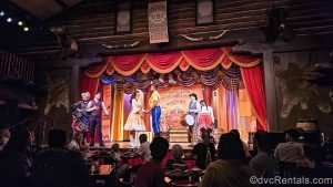 Cast Members perform on stage in frontier-inspired costumes during the Hoop-Dee-Doo Musical Revue at Disney’s Fort Wilderness Resort.