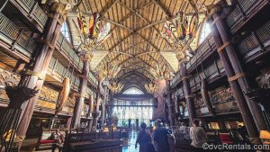Guests explore the African-inspired décor and artifacts in the lobby of Disney’s Animal Kingdom Villas Jambo House.