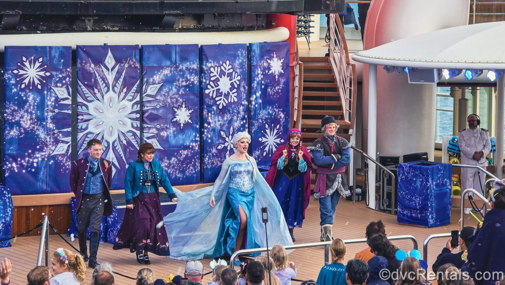 Characters Elsa, Anna, Kristoff, and the Royal Historians perform during the Frozen Deck Party onboard the Disney Magic.