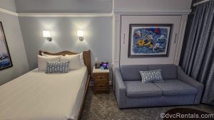 A Studio at Disney’s Beach Club Villas. The room is decorated with blues and greys, along with nautical art and accessories inspired by Donald and Daisy Duck.