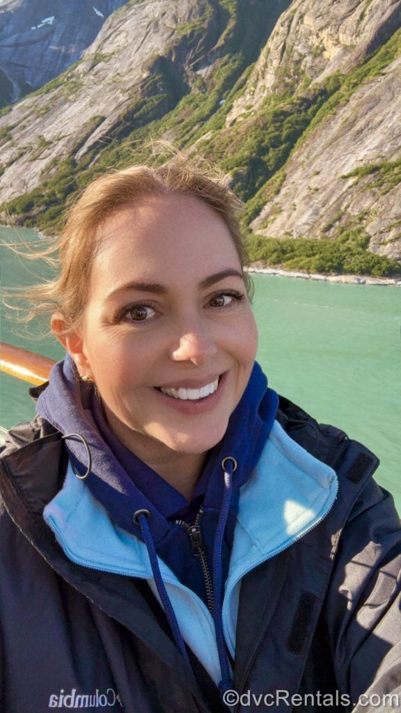 David’s Vacation Club Rentals team member Stacy R. smiles in a selfie showcasing layers of clothing for the weather as the Disney Magic sails through Alaska.