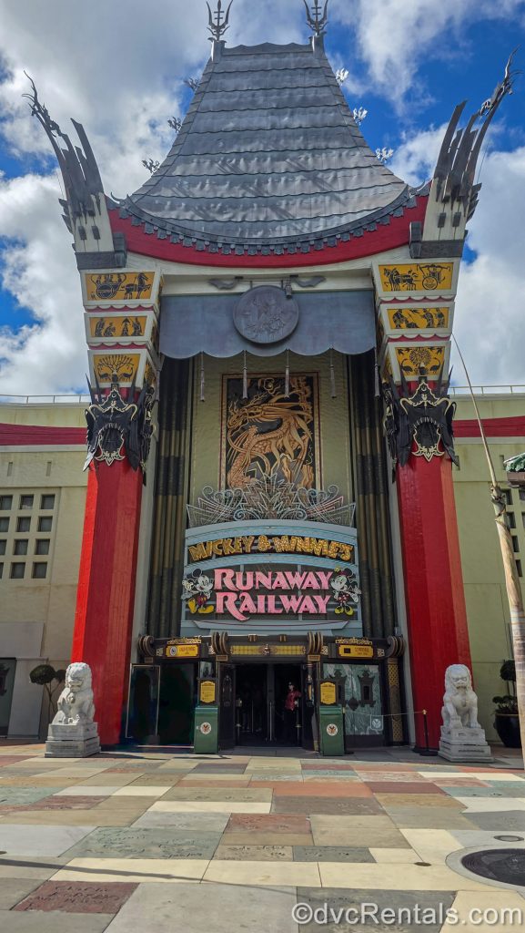 The entry to the Mickey & Minnie’s Runaway Railway attraction in the recreation of Hollywood’s iconic Grauman’s Chinese Theatre is seen at Disney’s Hollywood Studios under a blue sky.