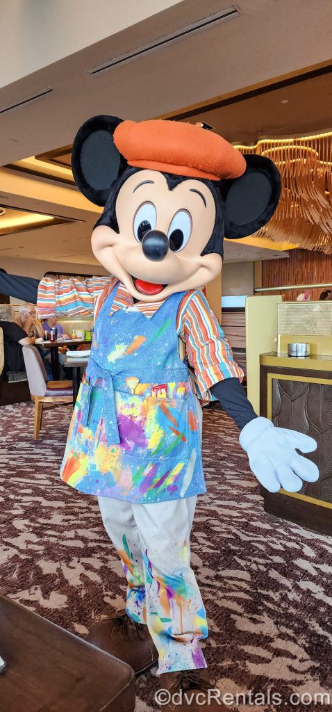 Mickey Mouse poses for a photo in his European painter-inspired outfit during breakfast at Topolino’s Terrace at Disney’s Riviera Resort.